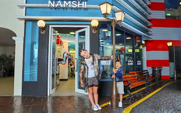 Children playing outside Namshi store at Fashion Street, Kidzania, Abu Dhabi.