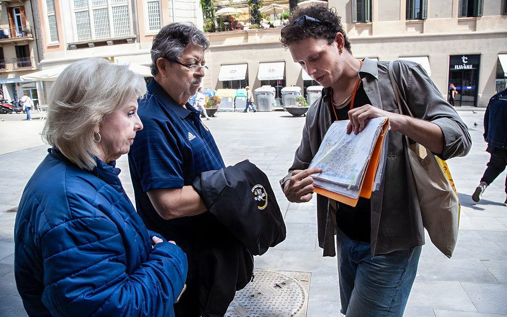 Tour guide showing a map to visitors during Barcelona's Raval walking tour.