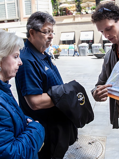 Tour guide showing a map to visitors during Barcelona's Raval walking tour.