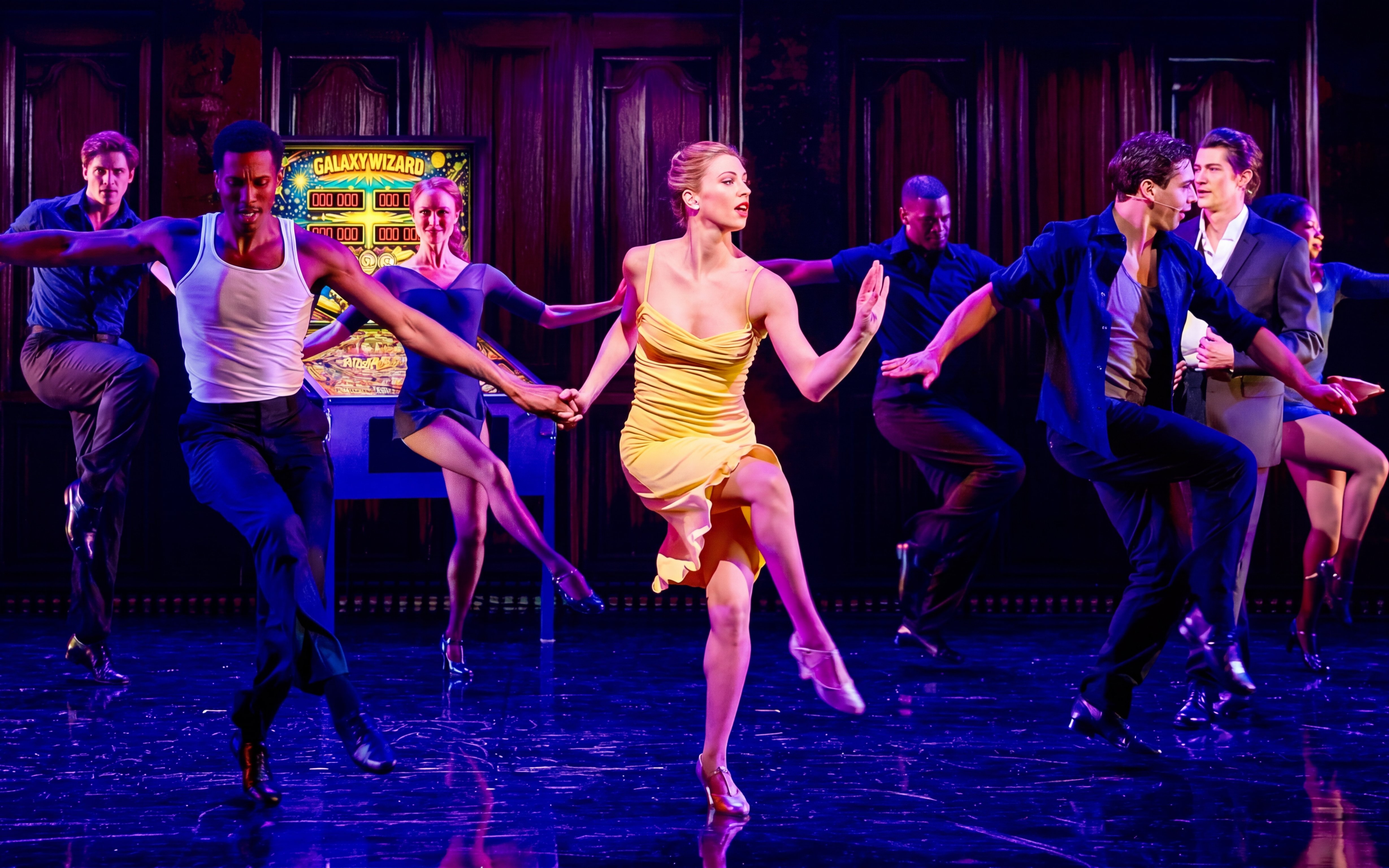 Dancers performing a lively routine on stage, showcasing "Gotta Dance!" tour.