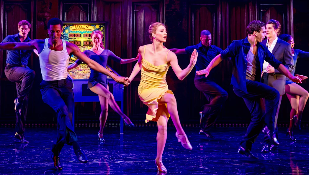 Dancers performing a lively routine on stage, showcasing "Gotta Dance!" tour.