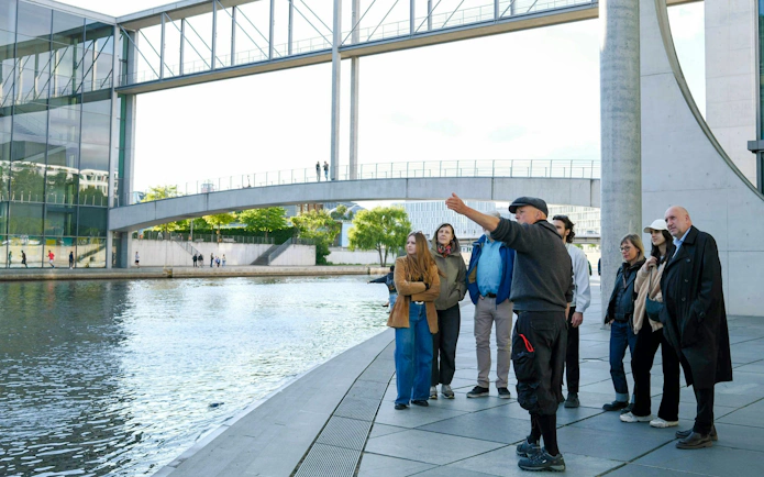 Tour group exploring the Government District near the Reichstag Dome, Berlin.