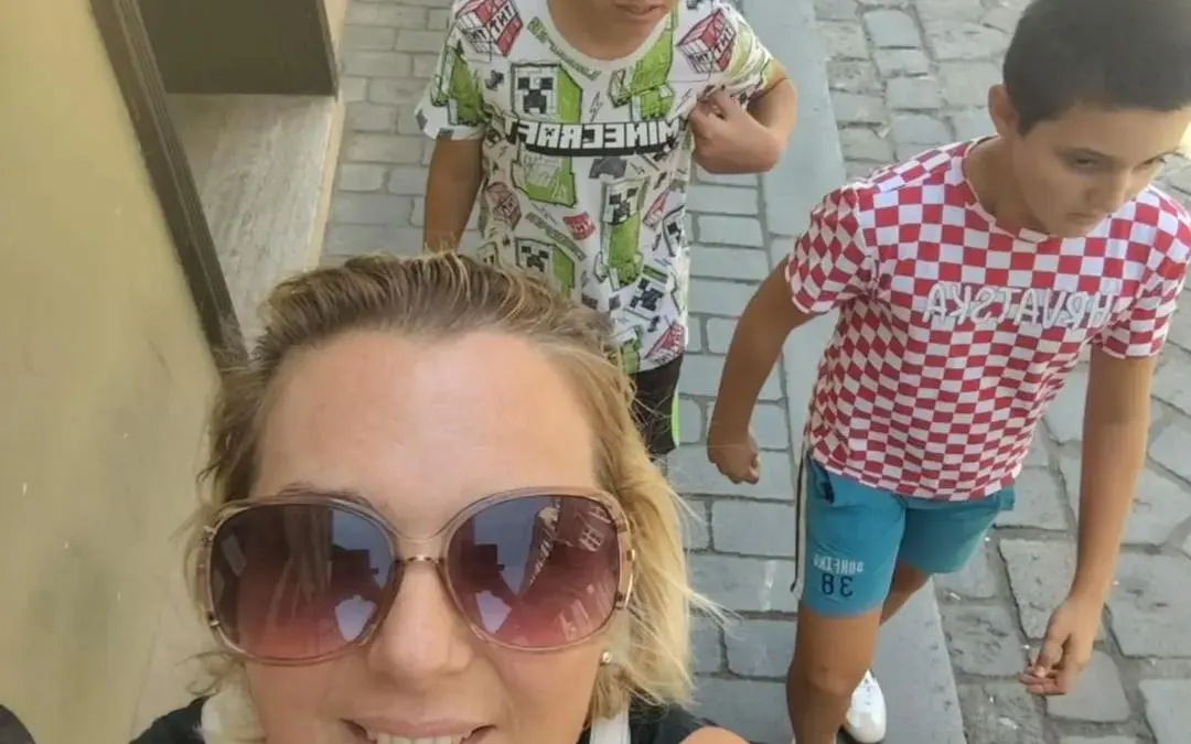 Family exploring cobblestone streets on Zagreb self-guided city game tour.