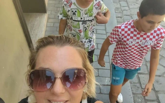 Family exploring cobblestone streets on Zagreb self-guided city game tour.