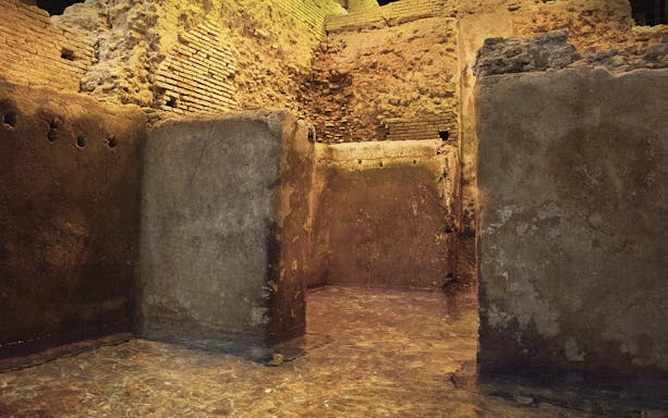 Trevi Underground ancient stone walls with water, Rome.