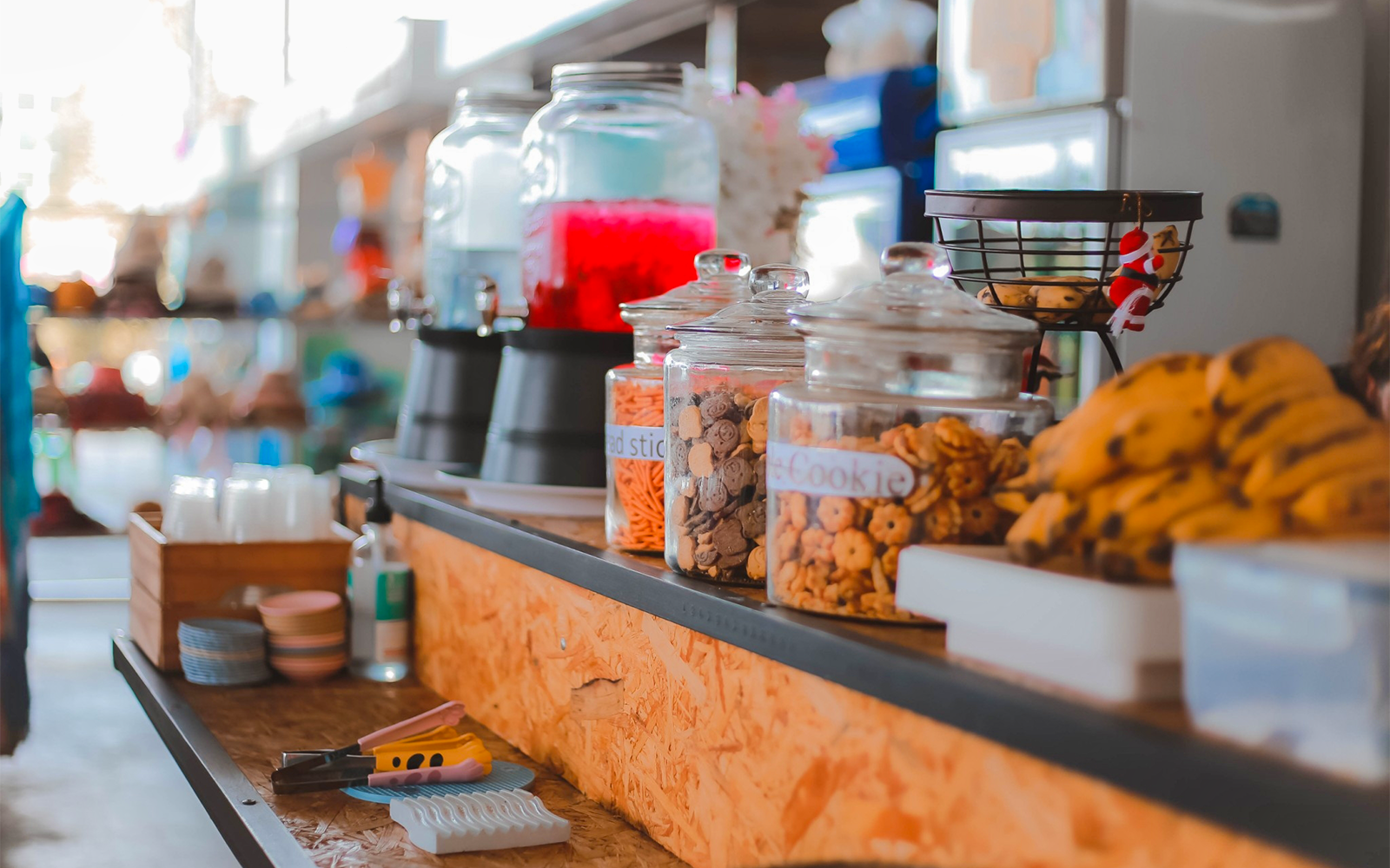 Food and drinks counter with beverage dispensers and cookie jars in Phuket.