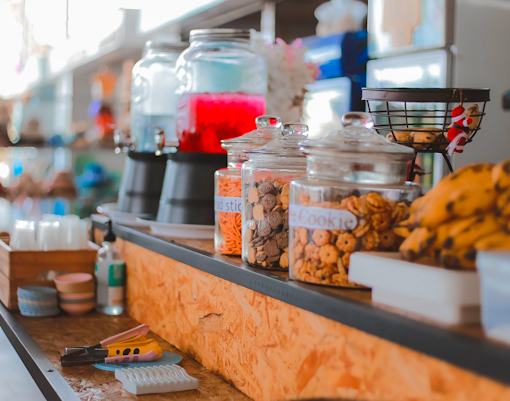 Food and drinks counter with beverage dispensers and cookie jars in Phuket.