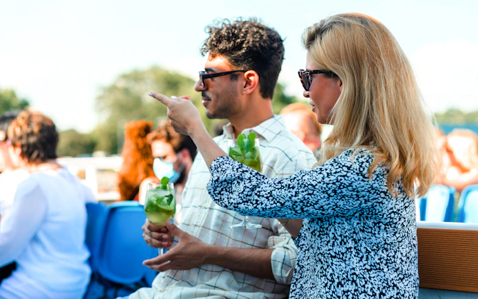 Guests enjoying drinks on Helsinki sightseeing cruise deck.