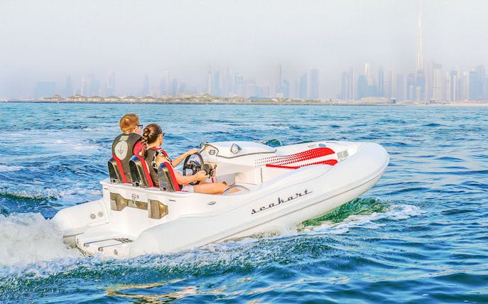 Jet boat on Dubai waters with city skyline in background, Adventure Zone Watersports.
