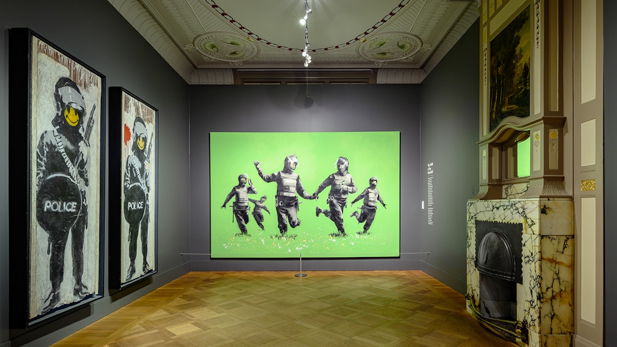 Visitors viewing Banksy artworks at Moco Museum, Amsterdam with Moco Museum Tickets.