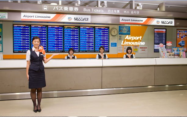Airport Limousine counter staff at Narita Airport for bus transfers to Tokyo and Shinjuku.