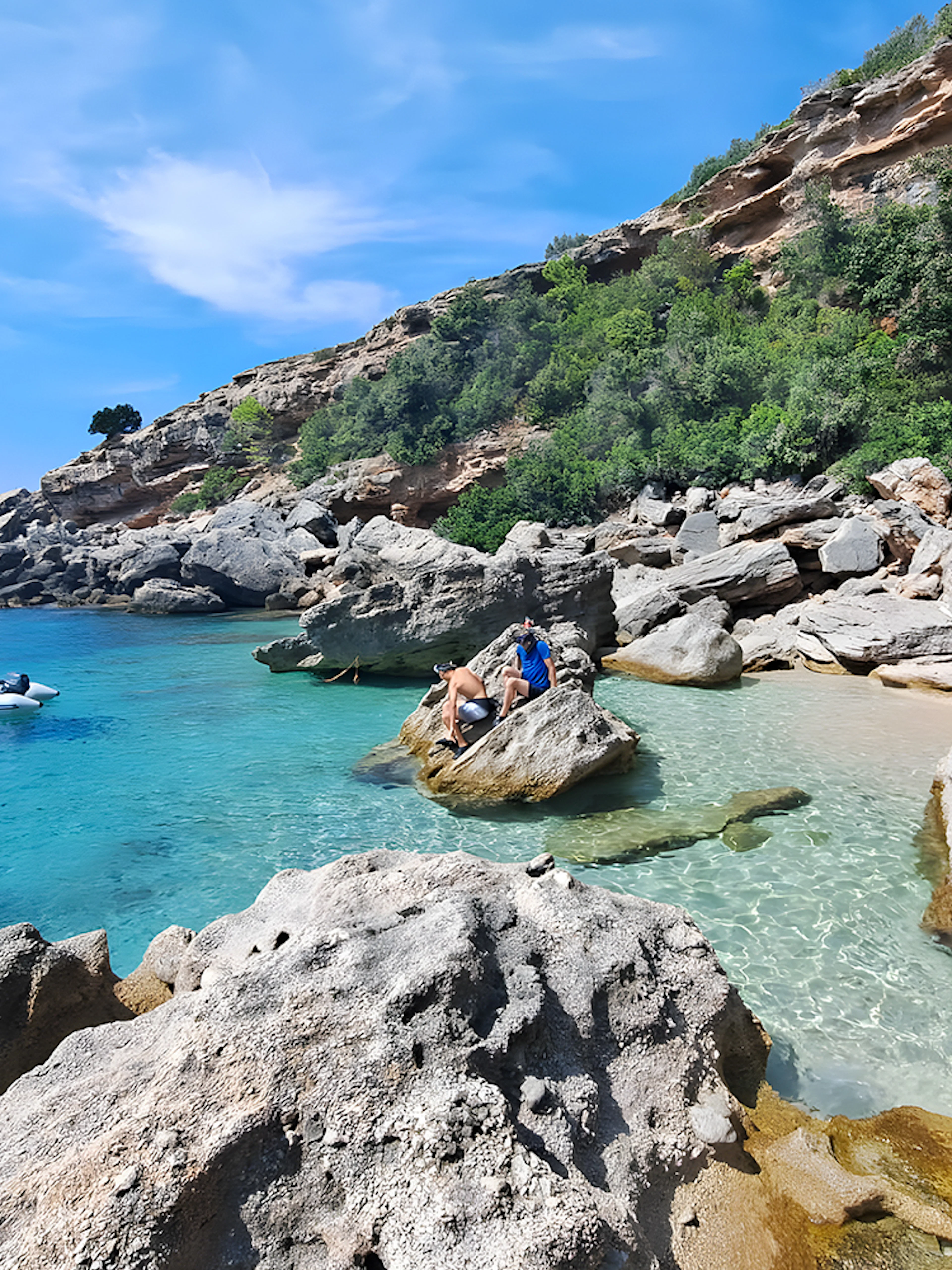 Snorkeling and swimming at a secluded beach in Korčula, Dubrovnik with rocky cliffs and clear blue water.