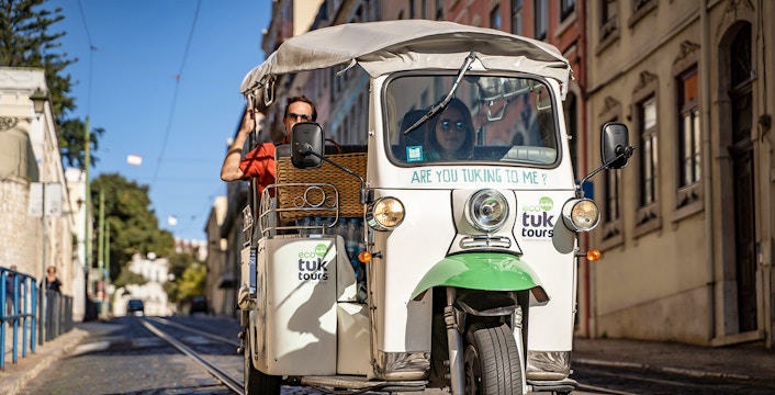 Private electric tuk tuk on cobblestone street during half day sightseeing tour.