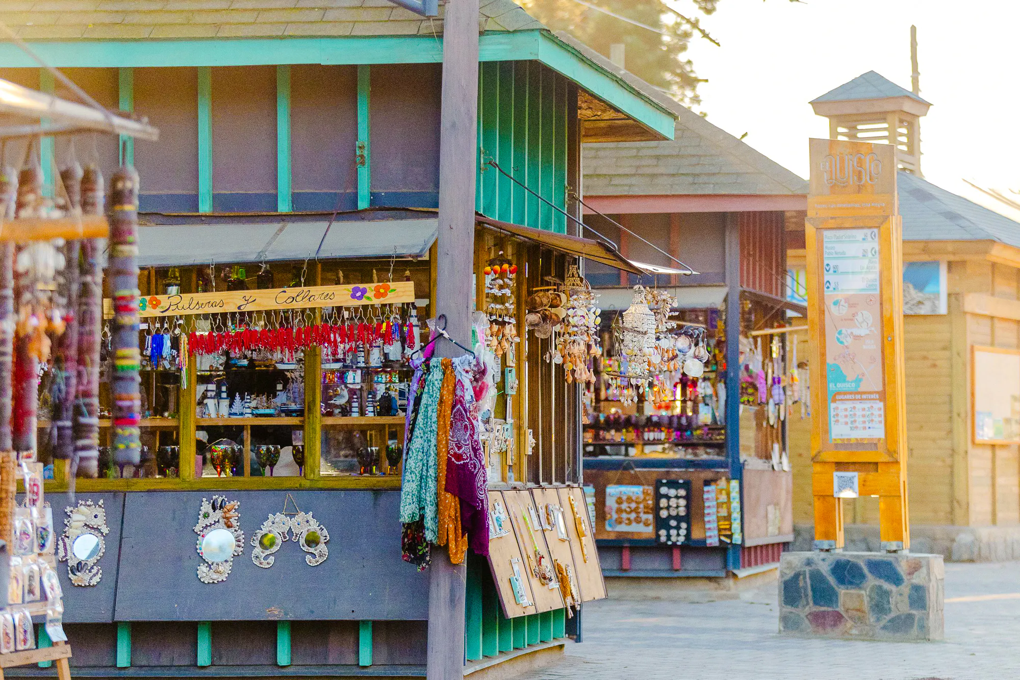 Market stalls with crafts and souvenirs in Isla Negra, part of the Santiago day tour.