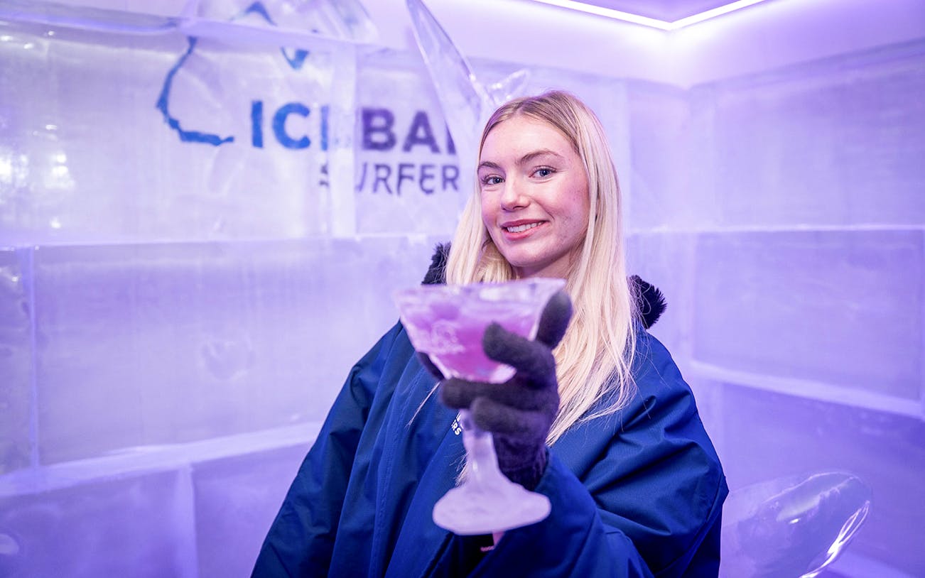 Person holding a drink inside IceBar Surfers Paradise, surrounded by ice decor.