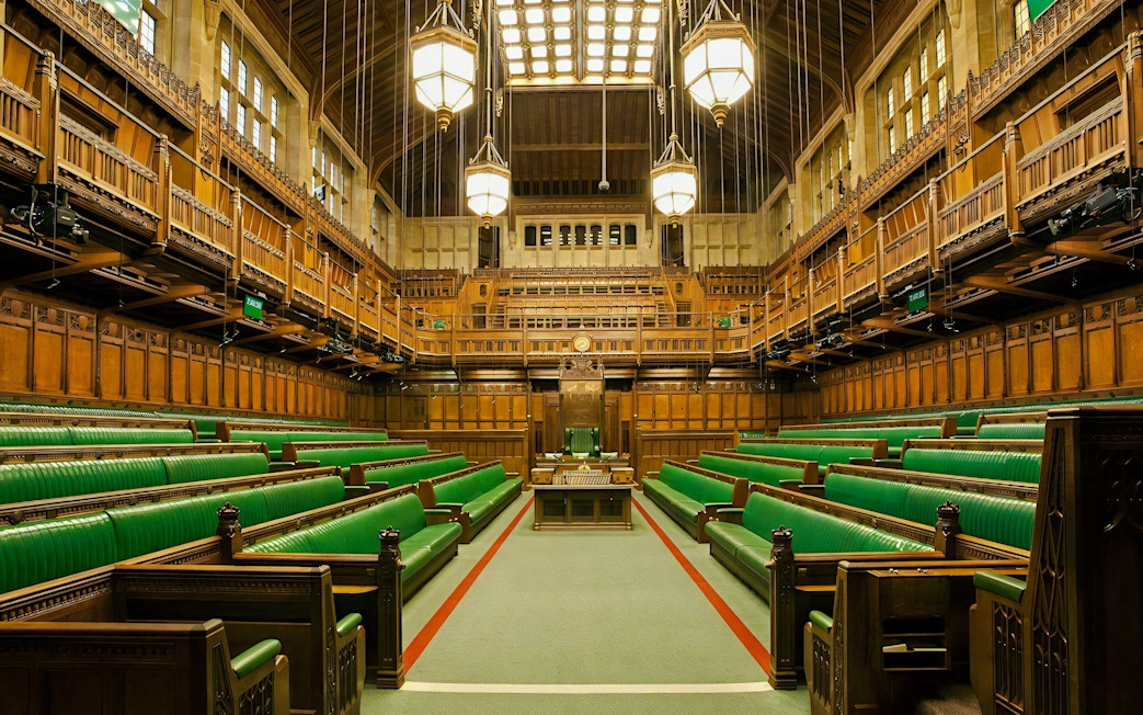 Chamber of the House of Commons with green benches, Houses of Parliament, London.