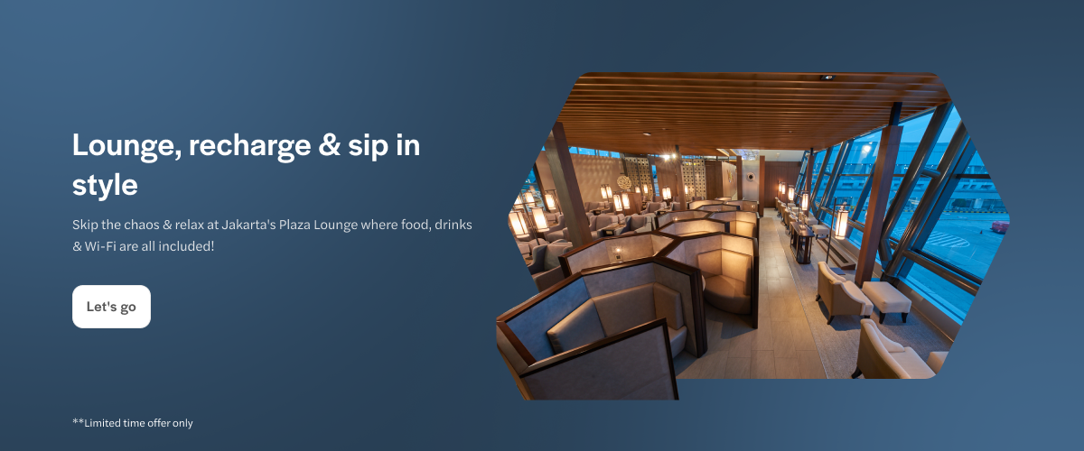 Jakarta Plaza Lounge interior with seating and large windows.