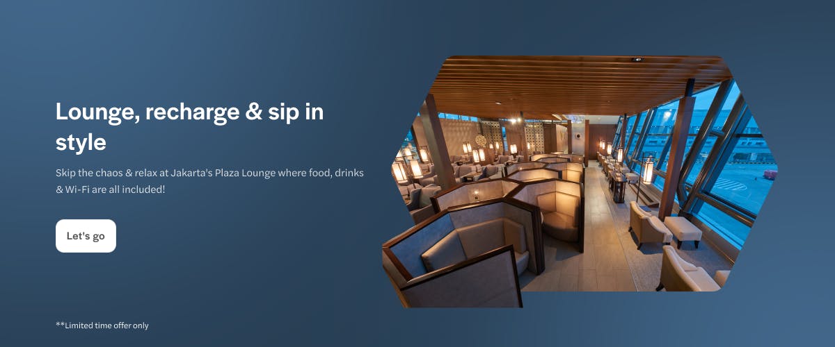 Jakarta Plaza Lounge interior with seating and large windows.