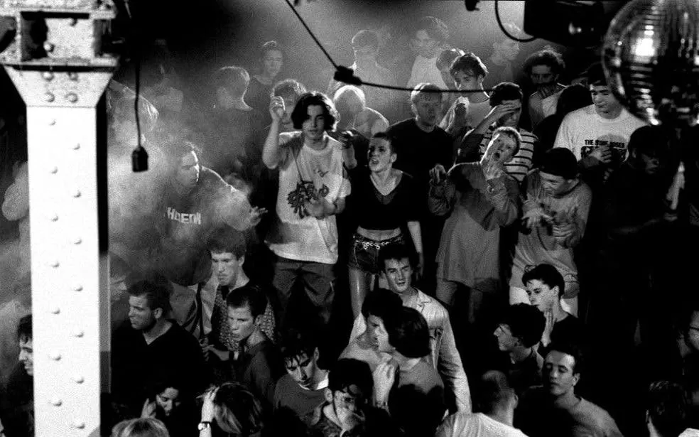 Crowd dancing at a Manchester club during the 80s and 90s music scene.