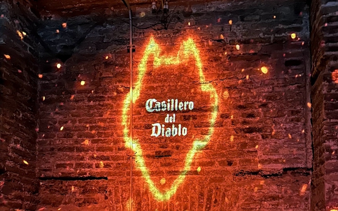 Casillero del Diablo logo projected on a brick wall with glowing effect