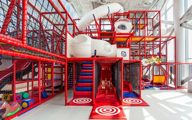 Indoor play area with slides and climbing structures at Macau Kids City.