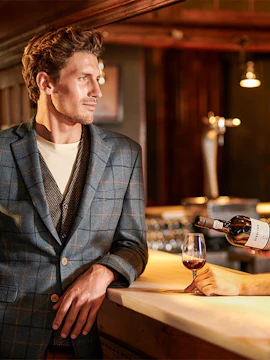Man at Burmester Wine Cellar bar with glass of wine being poured.
