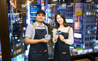 Participants holding repaired pottery at Kintsugi workshop in Shinjuku, Tokyo.