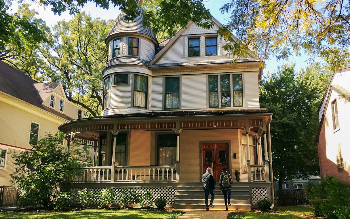 Victorian house in Chicago with two people approaching the entrance.