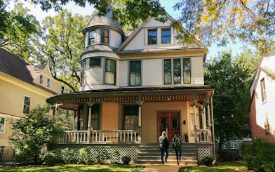 Victorian house in Chicago with two people approaching the entrance.