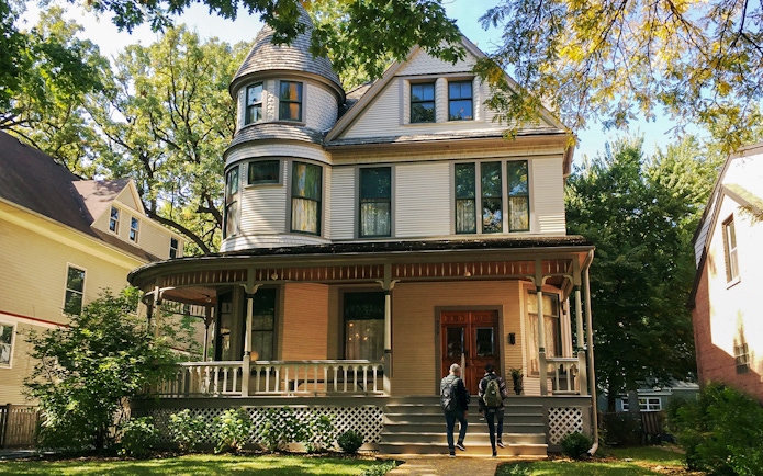 Victorian house in Chicago with two people approaching the entrance.