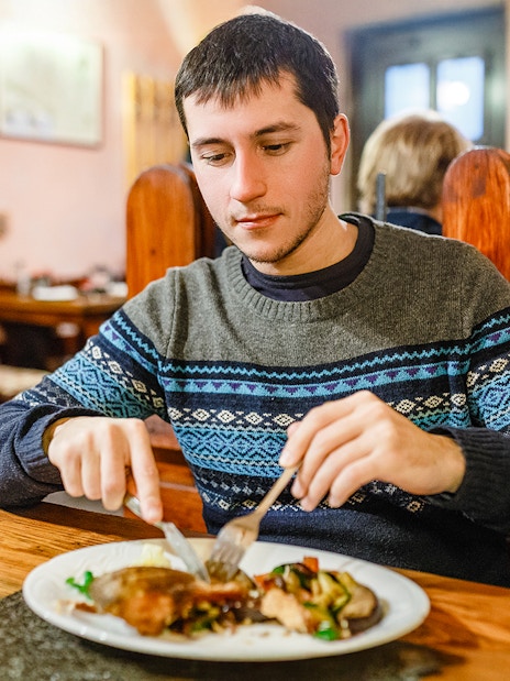 Man enjoying traditional Czech dinner during Prague beer tour.