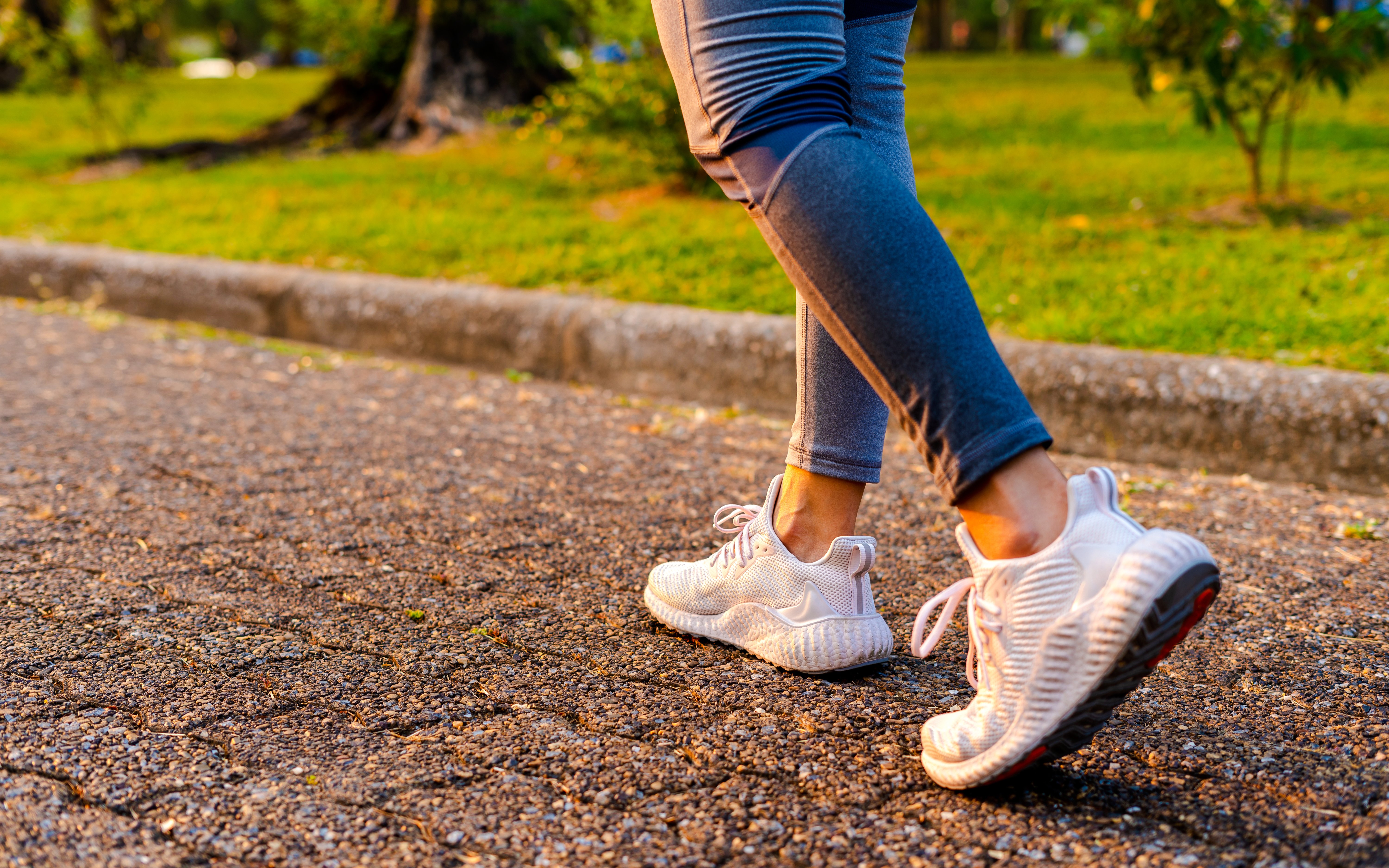 Walking on a park path in athletic shoes.