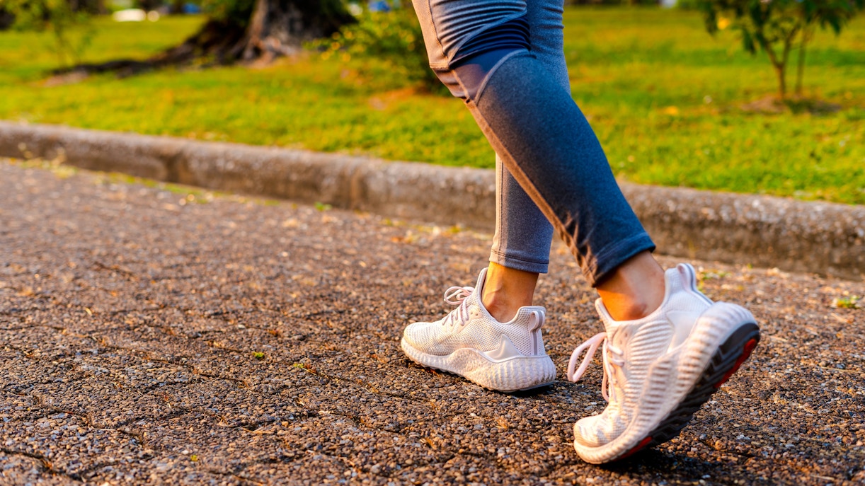 Walking on a park path in athletic shoes.