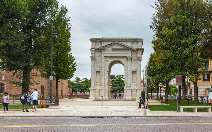 Verona's Porta Borsari arch with tourists nearby on a walking tour.