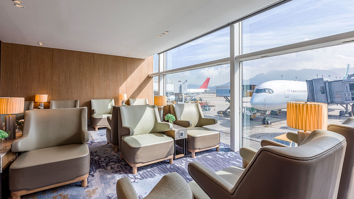 Plaza Premium Lounge seating area with airport view in Hong Kong.