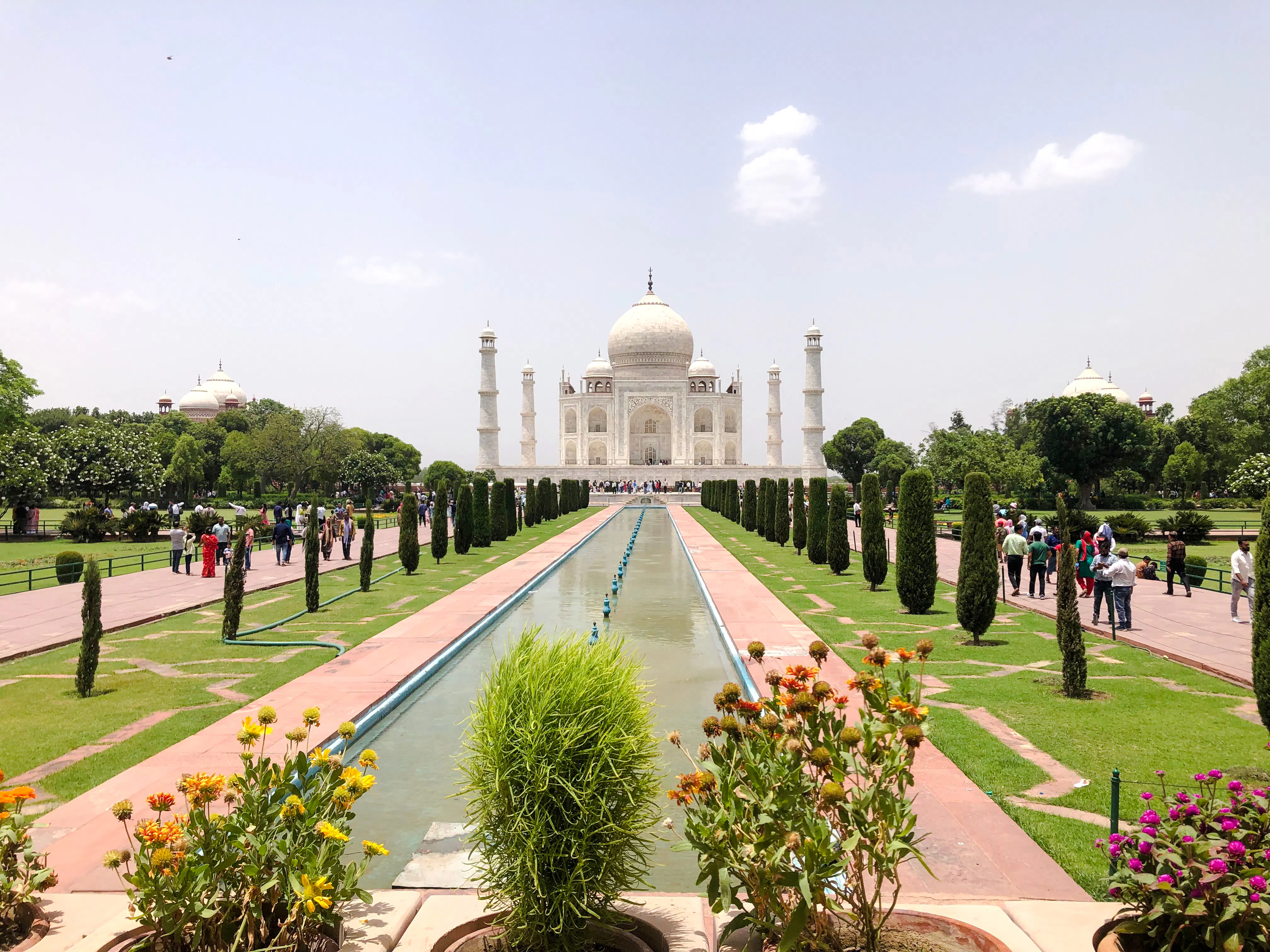 Taj Mahal view with gardens and reflecting pool, Agra day tour from Delhi.