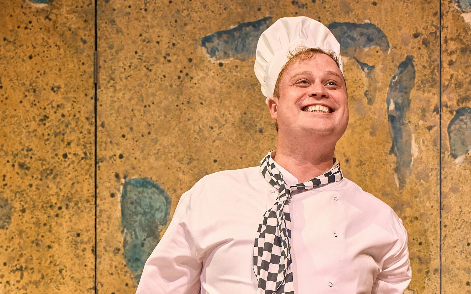 Mother Goose pantomime performance at London theater with vibrant costumes and lively stage setting.