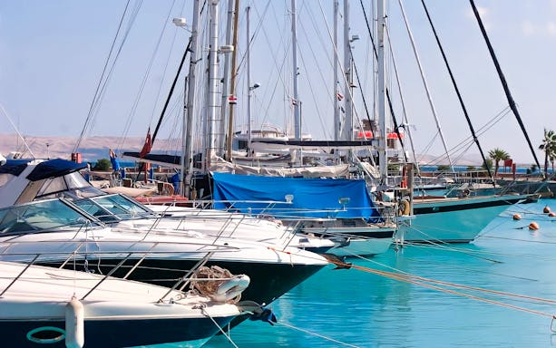 Sailboats docked in Hurghada marina during city highlights tour.