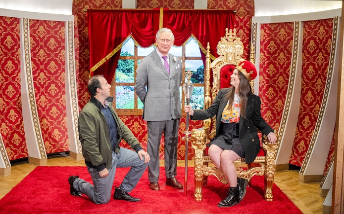 Wax figure of King Charles with visitors at Madame Tussauds Sydney.