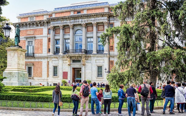 Prado Museum entrance with guided group in Madrid, Spain.