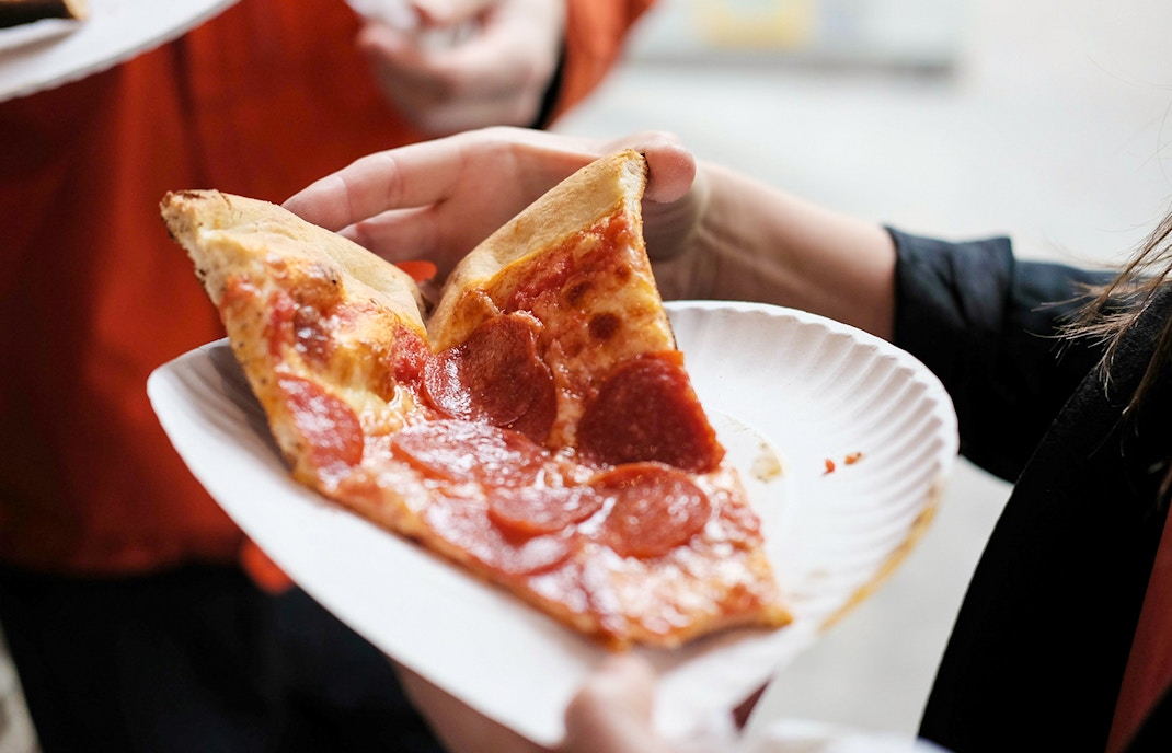 Freshly baked pizza slice in a white plate at PortAventura