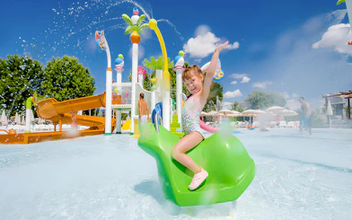 Child enjoying water slide at Parque Warner Beach.