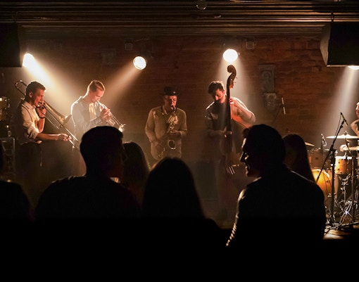 Concertgoers enjoying a modern jazz performance in a vibrant setting.