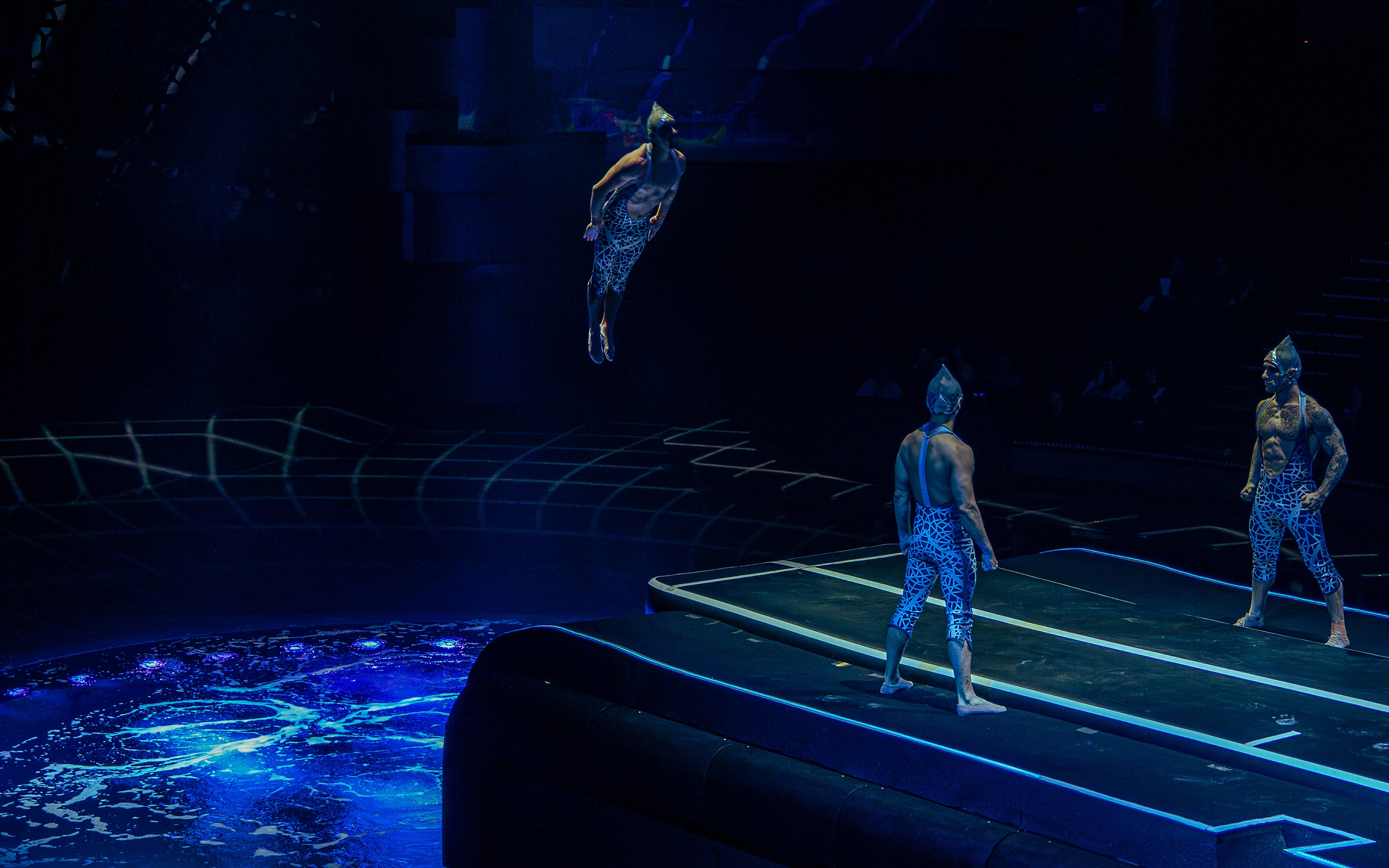 Acrobats performing a high dive at La Perle show in Dubai.