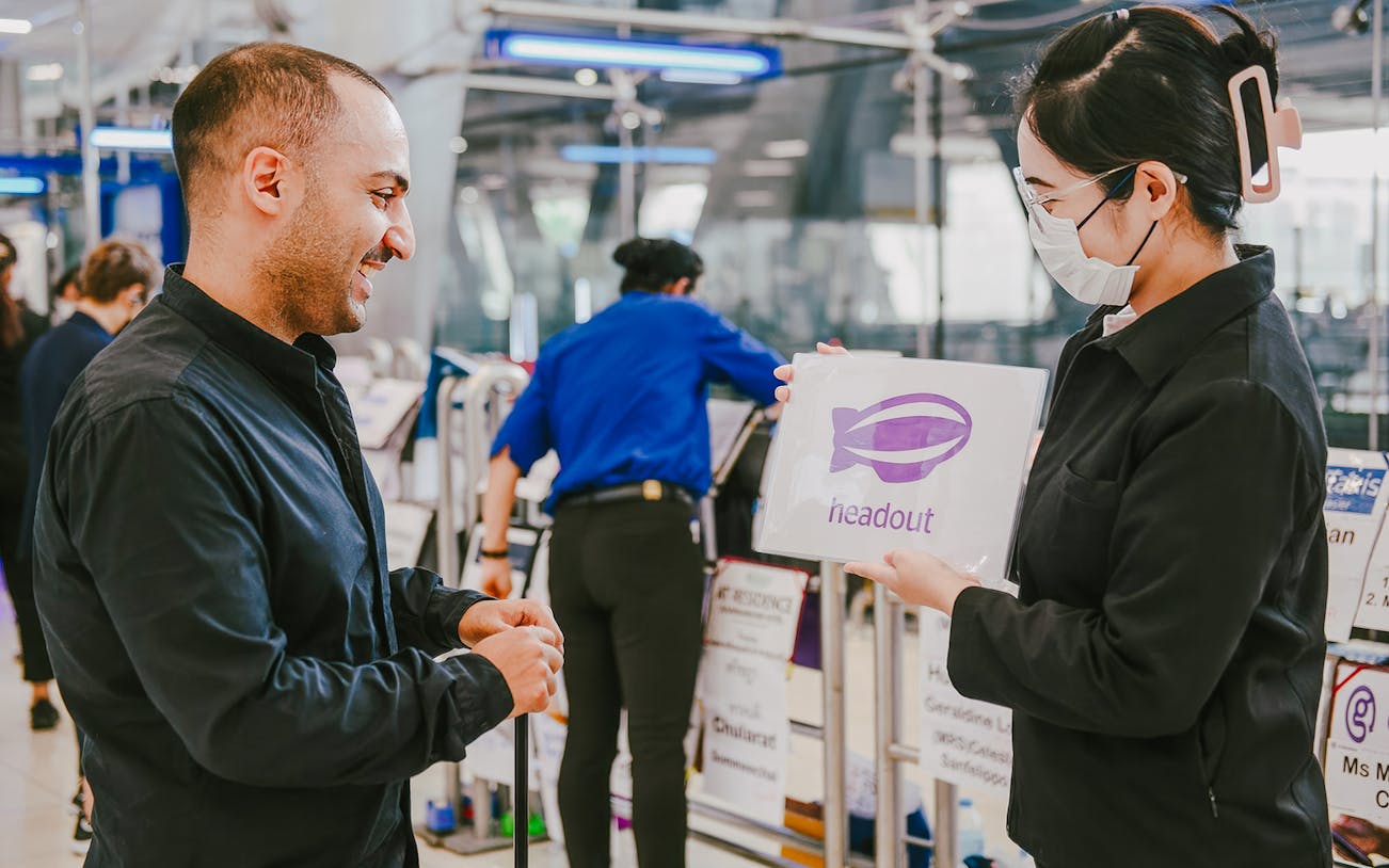 Headout representative greeting traveler at Suvarnabhumi Airport for private transfer.
