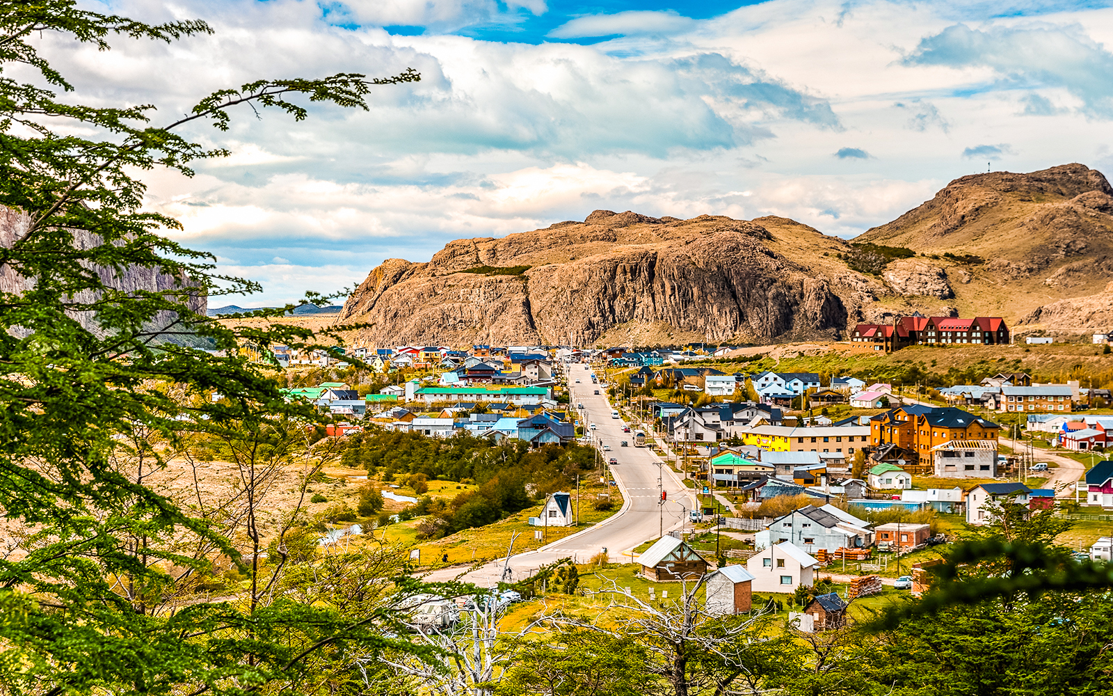 Aerial view of El Chaltén with colorful houses and Mount Fitz Roy in the background.