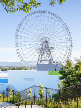 Ferris wheel at Redhorse Osaka with clear blue sky.
