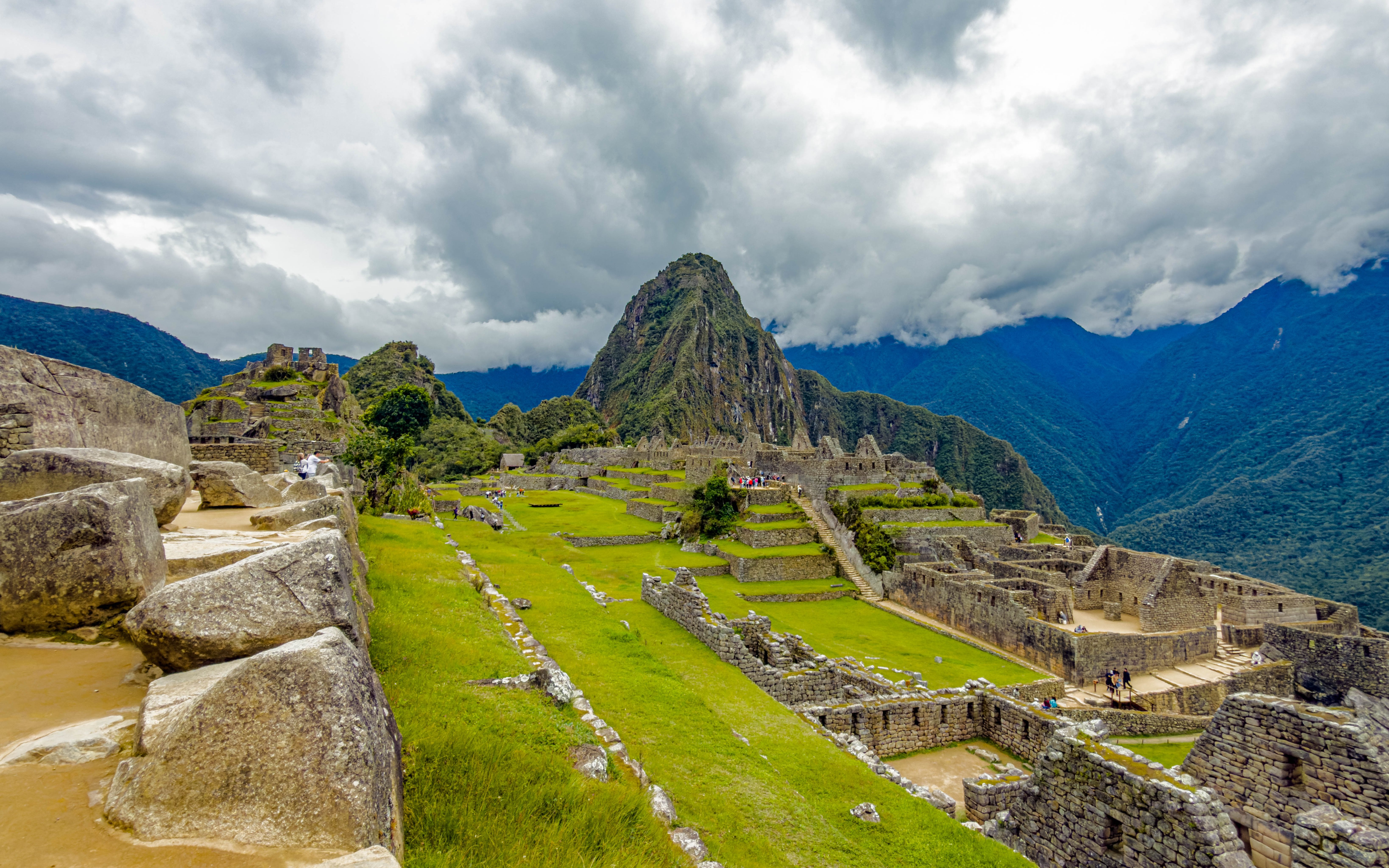 Stone structures and terraces at Machu Picchu with mountain backdrop.