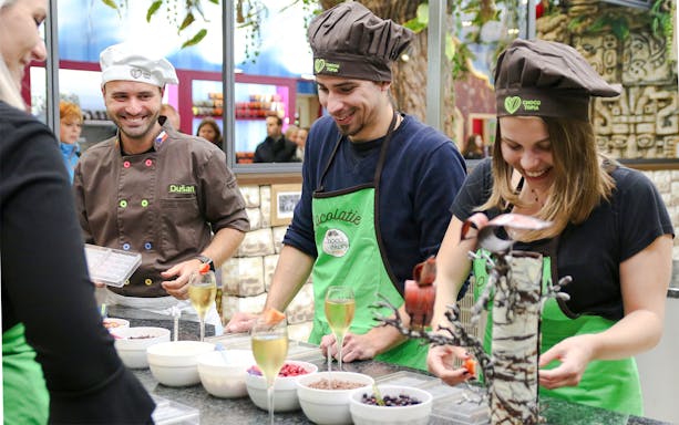 Visitors crafting chocolate at Chocotopia workshop, Prague.
