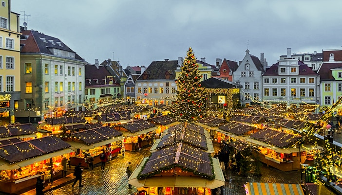 Stockholm Christmas market with festive lights and decorated stalls in a historic square.